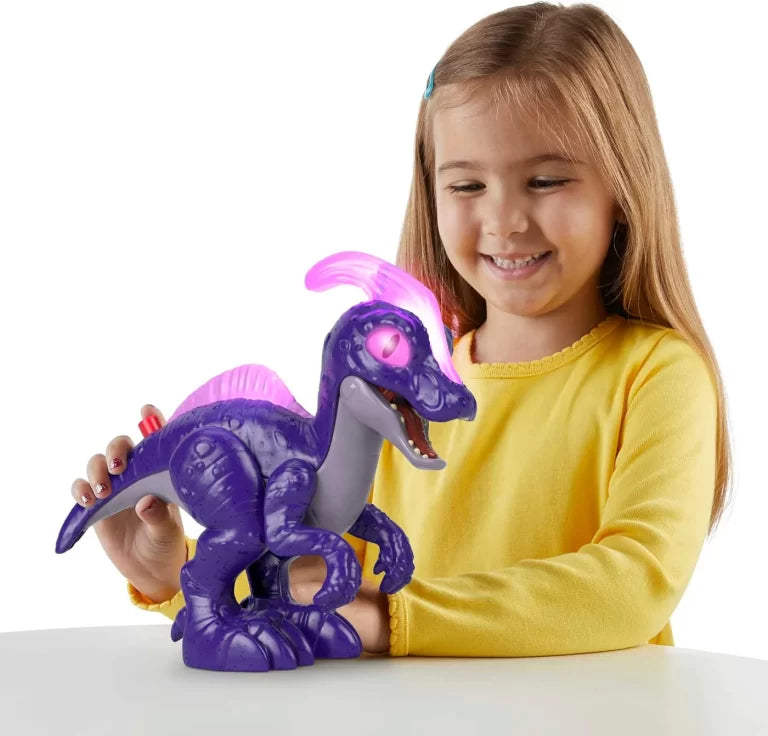 Child holding a purple toy dinosaur with a light-up feature on a white background