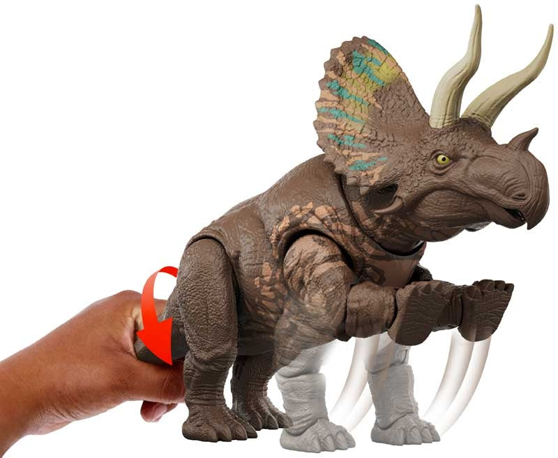 Toy triceratops figure held by a hand on a white background