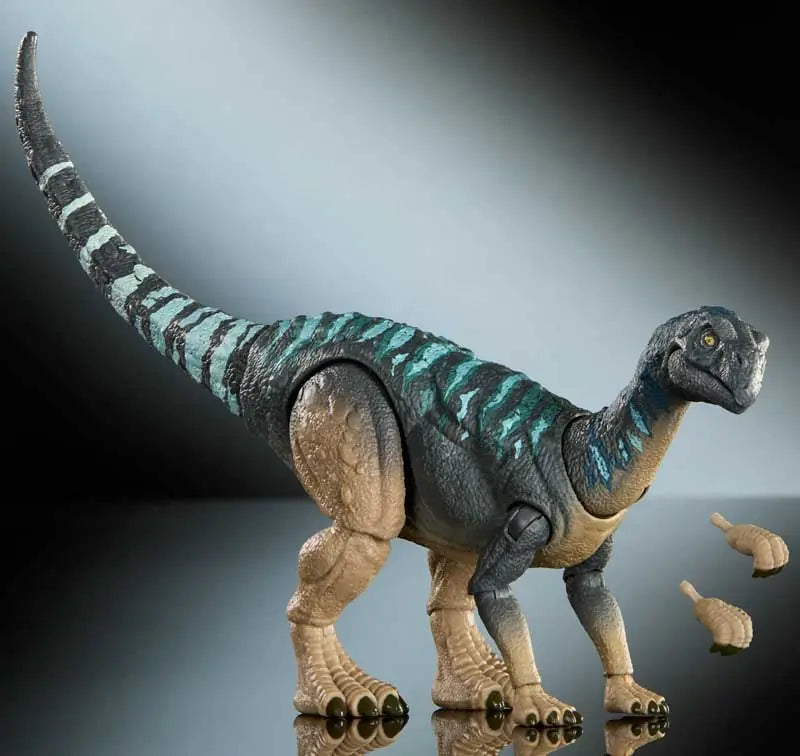 Dinosaur toy figure with a striped pattern on a reflective surface