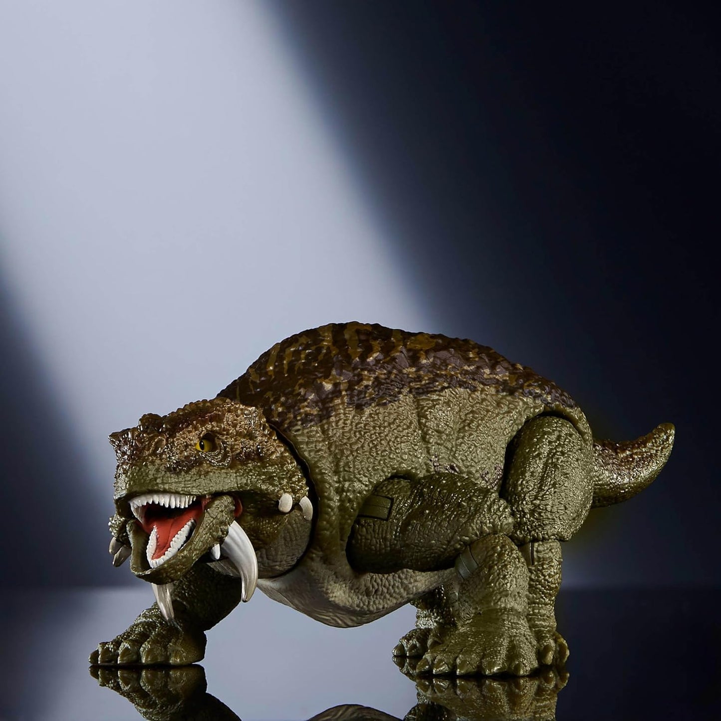 Toy dinosaur figure on a reflective surface with a dark background