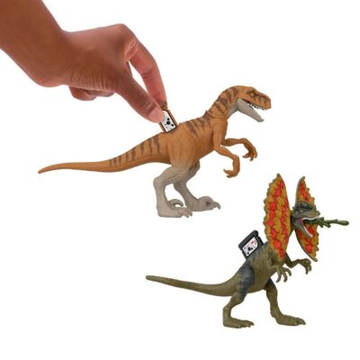 Two toy dinosaurs, one brown and one green with red crest, on a white background.