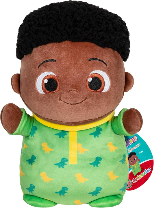 Plush toy of a child in green pajamas with dinosaur pattern, wearing a black hat.