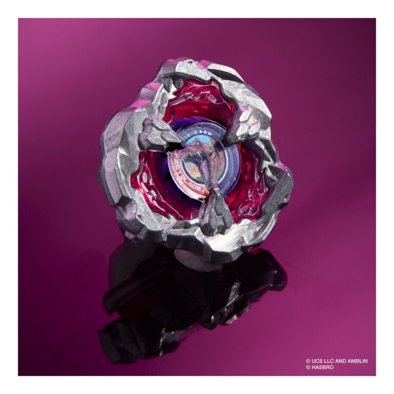 Toy beyblade with metallic and red design on a purple background