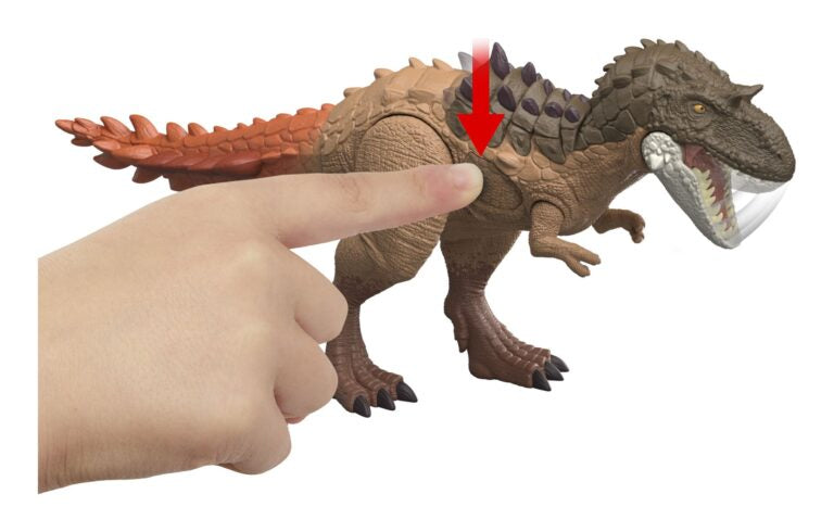 Toy dinosaur figure with a hand pressing a button on its back, on a white background