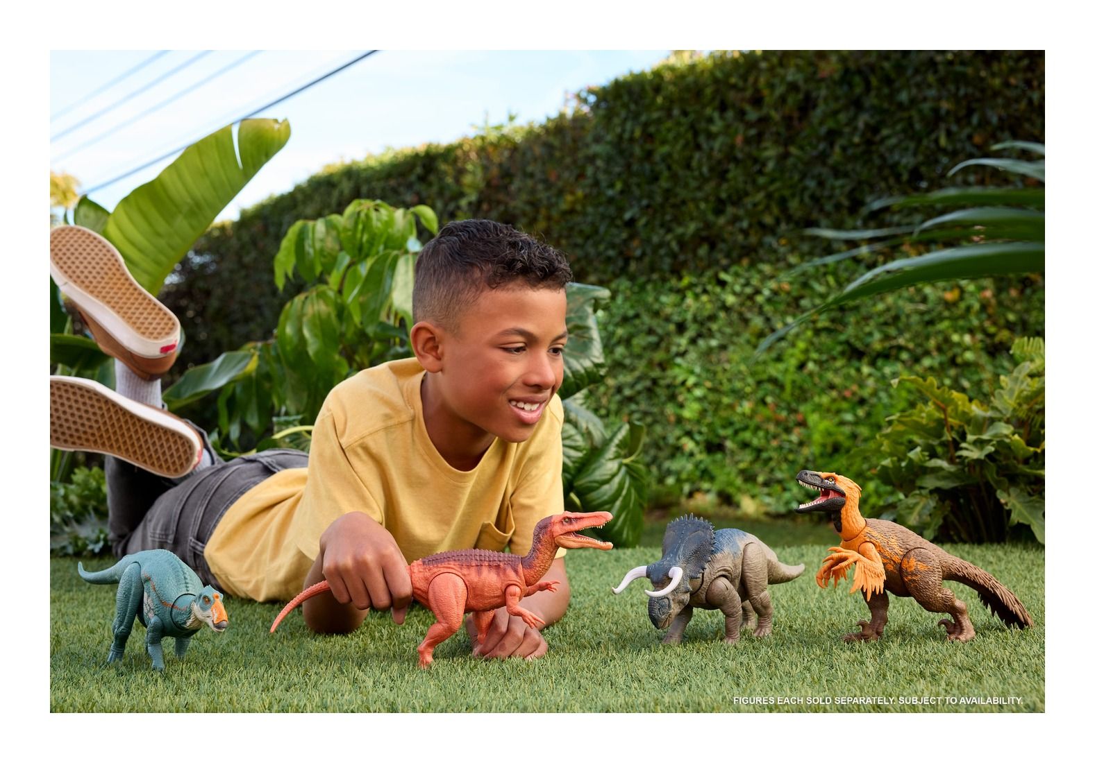 Child playing with dinosaur toys outdoors