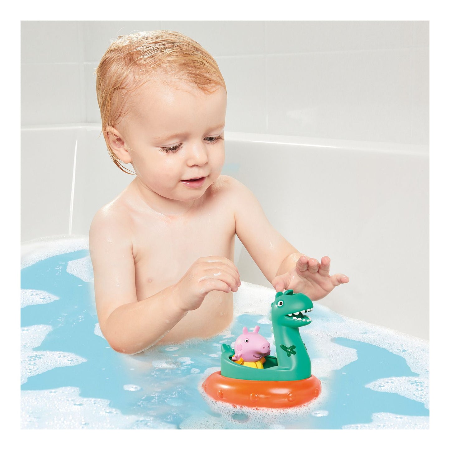 Child playing with a toy in a bathtub filled with water