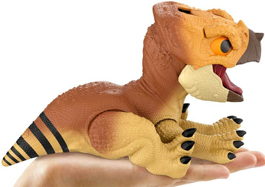 Toy dinosaur with open mouth held in a hand on a white background