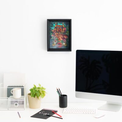 Modern office desk with computer, plant, and decorative items.