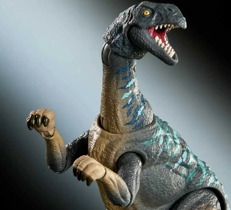 Dinosaur toy figure with a gray and blue color scheme on a dark background