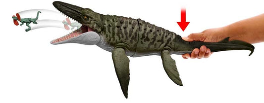Toy alligator with a hand holding it on a white background